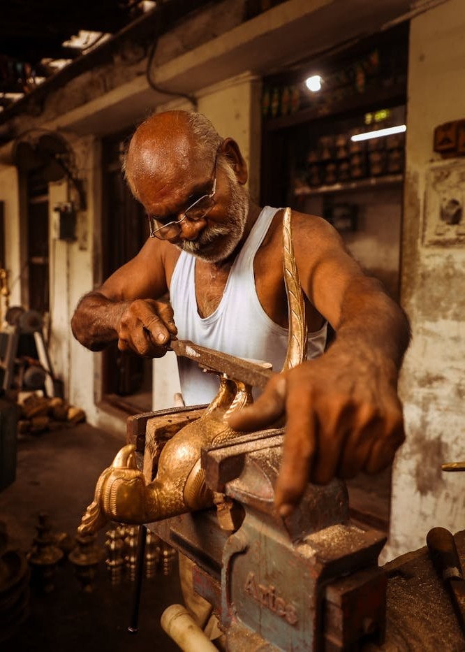 Subhash Pudru working on a brass hawk.